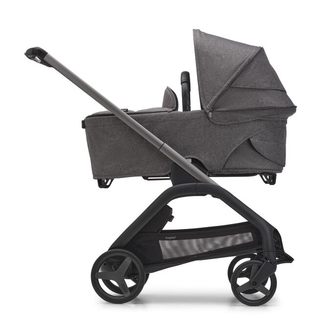 Side view of the Bugaboo Dragonfly bassinet stroller with graphite chassis, grey melange fabrics and grey melange sun canopy.