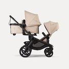 Bugaboo Kangaroo 2-in-1 tandem stroller with one bassinet above and one seat below, with Desert Taupe fabrics and Desert Taupe sun canopies.