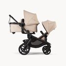 Bugaboo Kangaroo 2-in-1 tandem stroller with one bassinet above and one seat below, with Desert Taupe fabrics and Desert Taupe sun canopies.