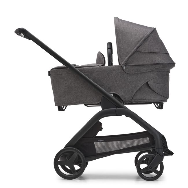 Side view of the Bugaboo Dragonfly bassinet stroller with black chassis, grey melange fabrics and grey melange sun canopy.
