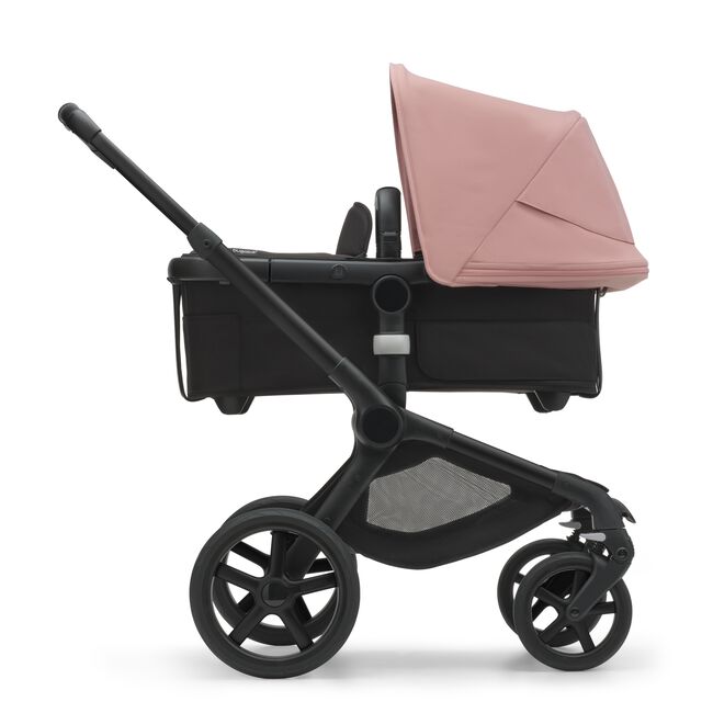 Side view of the Bugaboo Fox 5 carrycot pushchair with black chassis, midnight black fabrics and moring pink sun canopy. - Main Image Slide 3 of 16