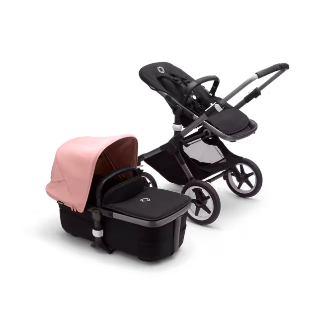 Bugaboo Fox 3 bassinet and seat stroller with graphite frame, black fabrics, and pink sun canopy. - Main Image Slide 5 of 7