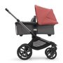 Side view of the Bugaboo Fox 5 bassinet stroller with graphite chassis, grey melange fabrics and sunrise red sun canopy. - Thumbnail Slide 3 of 16