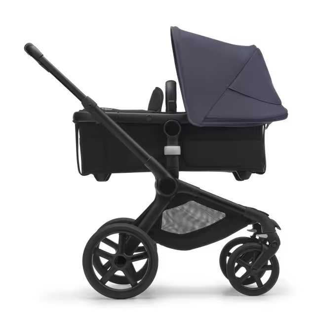 Side view of the Bugaboo Fox 5 carrycot pushchair with black chassis, midnight black fabrics and stormy blue sun canopy. - Main Image Slide 2 of 13