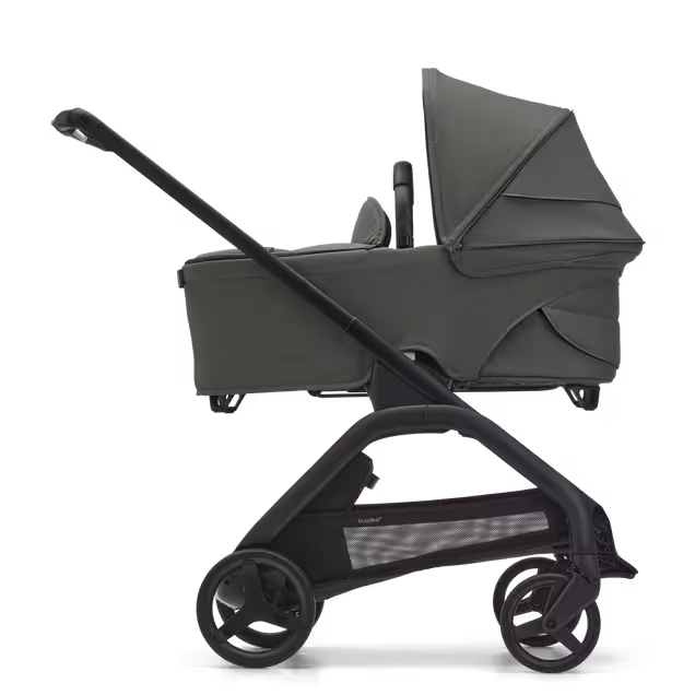 Side view of the Bugaboo Dragonfly carrycot pushchair with black chassis, forest green fabrics and forest green sun canopy. - Main Image Slide 3 of 16