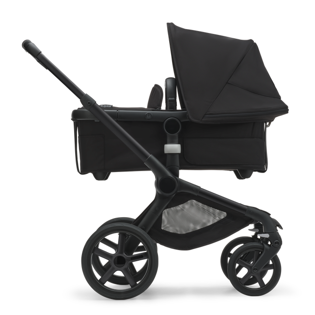 Side view of the Bugaboo Fox 5 bassinet stroller with black chassis, midnight black fabrics and midnight black sun canopy.