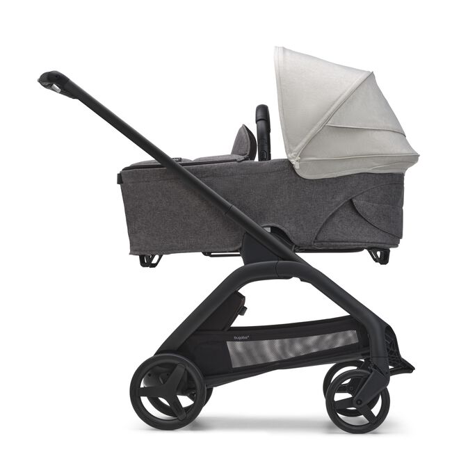 Side view of the Bugaboo Dragonfly bassinet stroller with black chassis, grey melange fabrics and misty white sun canopy.