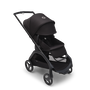 Bugaboo Dragonfly seat stroller with black chassis, midnight black fabrics and midnight black sun canopy. The sun canopy is fully extended.