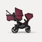 Bugaboo Kangaroo 2-in-1 tandem stroller with one bassinet above and one seat below, with Dark Cherry fabrics and Dark Cherry sun canopies.