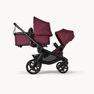 Bugaboo Kangaroo 2-in-1 tandem stroller with one bassinet above and one seat below, with Dark Cherry fabrics and Dark Cherry sun canopies.