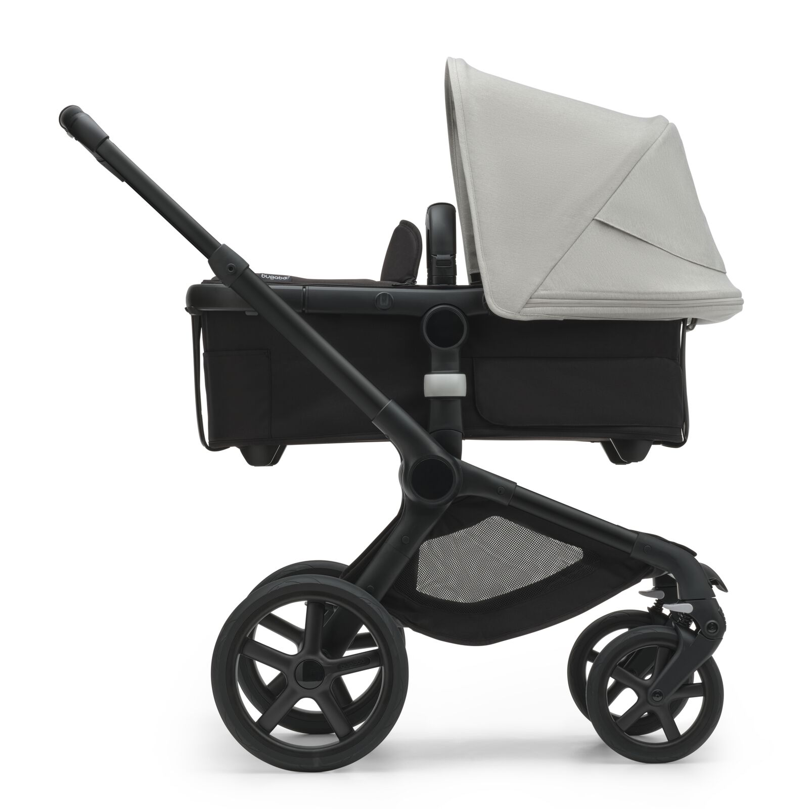 Side view of the Bugaboo Fox 5 bassinet stroller with black chassis, midnight black fabrics and misty white sun canopy.