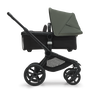 Side view of the Bugaboo Fox 5 bassinet stroller with black chassis, midnight black fabrics and forest green sun canopy. - Thumbnail Modal Image Slide 3 of 16