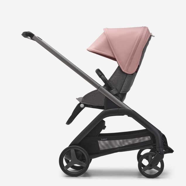 Vista laterale del passeggino con seduta Bugaboo Dragonfly con telaio graphite, tessuti grey melange e cappottina morning pink. - Main Image Slide 2 of 16