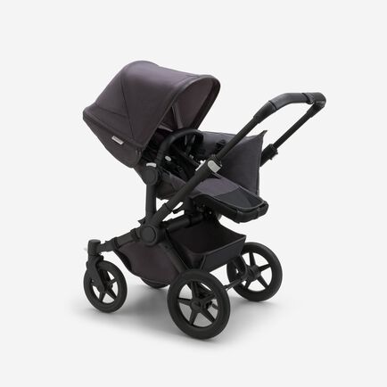 Bugaboo Donkey 5 Mono seat stroller with black chassis, mineral washed black fabrics and mineral washed black sun canopy.