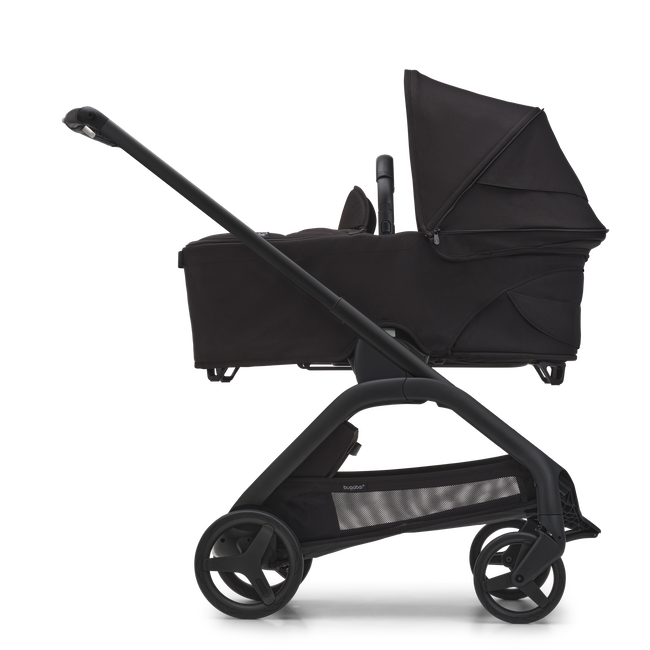 Side view of the Bugaboo Dragonfly bassinet stroller with black chassis, midnight black fabrics and midnight black sun canopy.