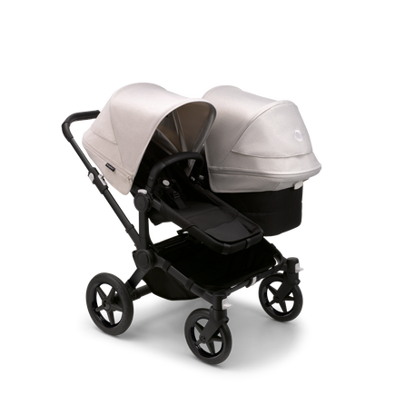 Bugaboo Donkey 5 Duo seat and bassinet stroller with black chassis, midnight black fabrics and misty white sun canopy.