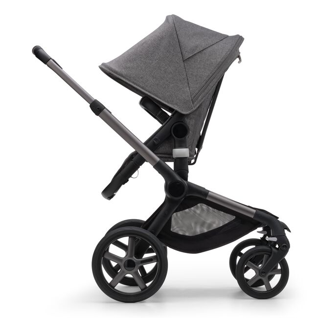 Side view of the Bugaboo Fox 5 seat stroller with graphite chassis, grey melange fabrics and grey melange sun canopy. - Main Image Slide 4 of 16