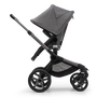 Side view of the Bugaboo Fox 5 seat stroller with graphite chassis, grey melange fabrics and grey melange sun canopy. - Thumbnail Slide 4 of 16