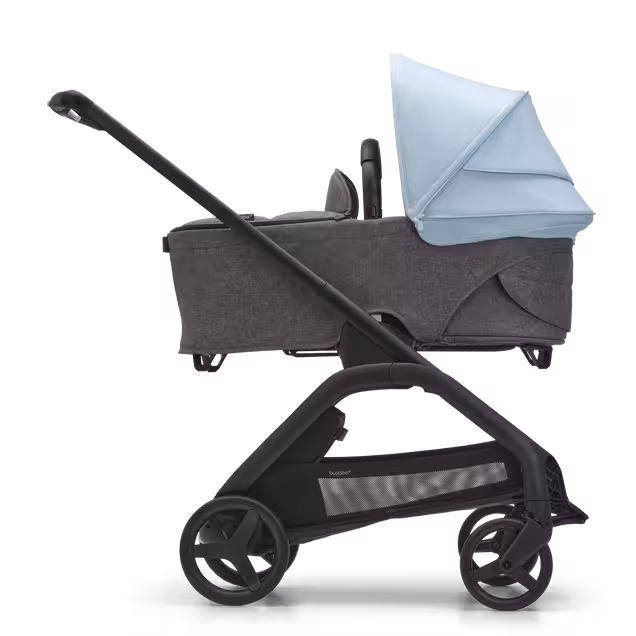 Side view of the Bugaboo Dragonfly bassinet stroller with black chassis, grey melange fabrics and skyline blue sun canopy. - Main Image Slide 3 of 16