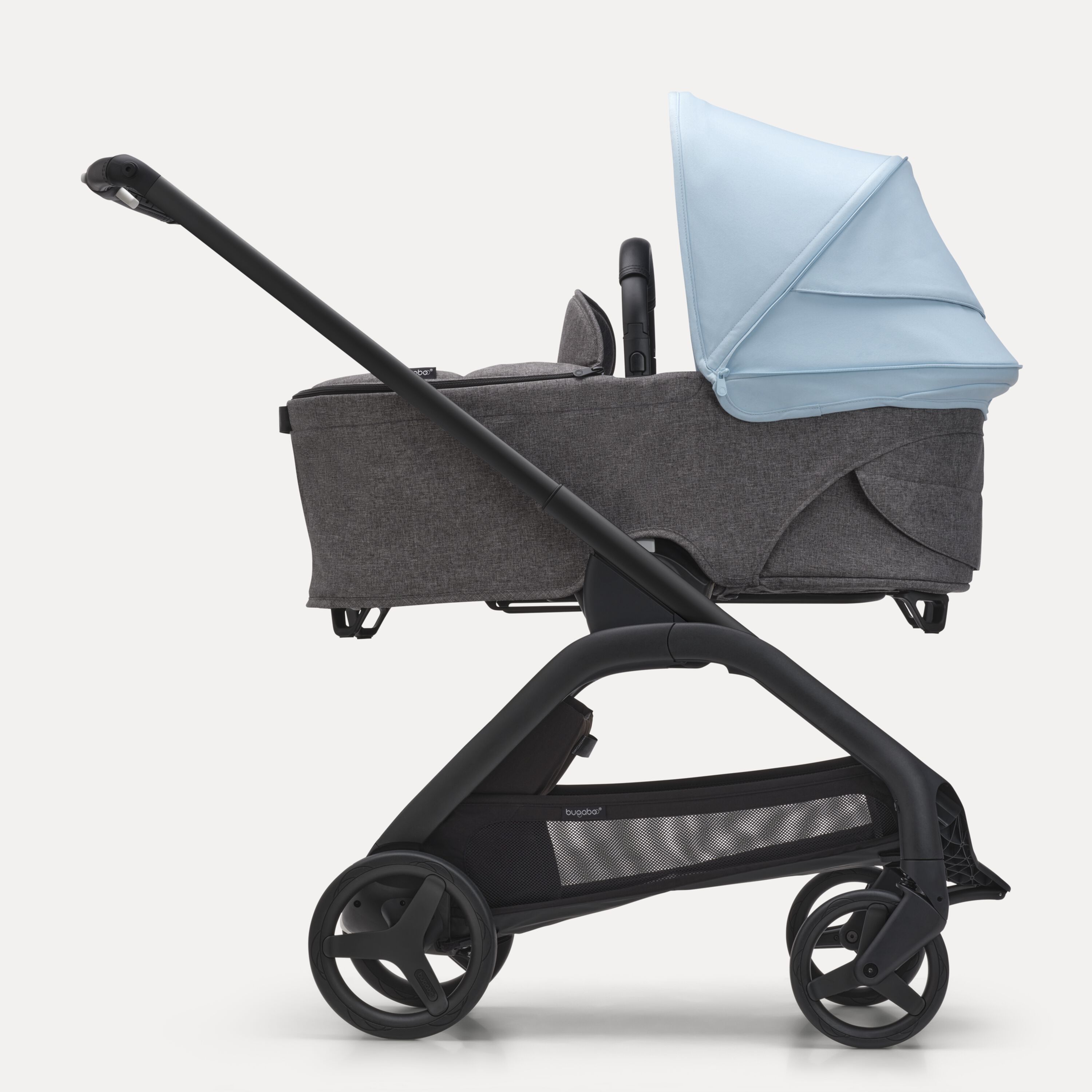 Side view of the Bugaboo Dragonfly bassinet stroller with black chassis, grey melange fabrics and skyline blue sun canopy. - Main Modal Image Slide 3 of 16