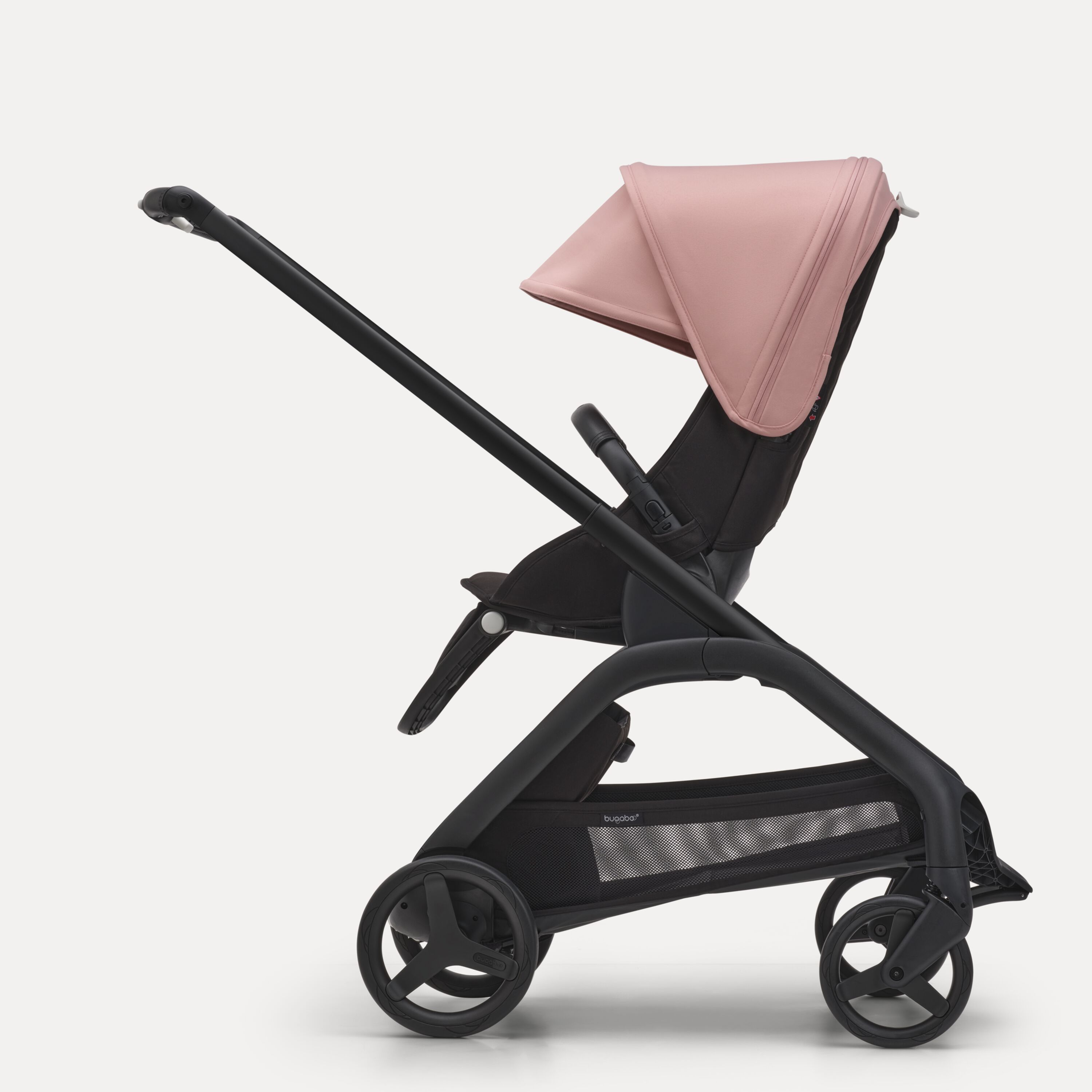 Side view of the Bugaboo Dragonfly seat stroller with black chassis, midnight black fabrics and morning pink sun canopy. - Main Modal Image Slide 2 of 16