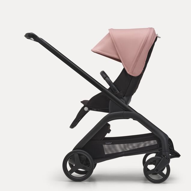 Side view of the Bugaboo Dragonfly seat stroller with black chassis, midnight black fabrics and morning pink sun canopy. - Main Image Slide 2 of 16