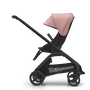 Side view of the Bugaboo Dragonfly seat stroller with black chassis, midnight black fabrics and morning pink sun canopy.