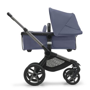 Side view of the Bugaboo Fox 5 bassinet stroller with graphite chassis, midnight black fabrics and stormy blue sun canopy. - view 2