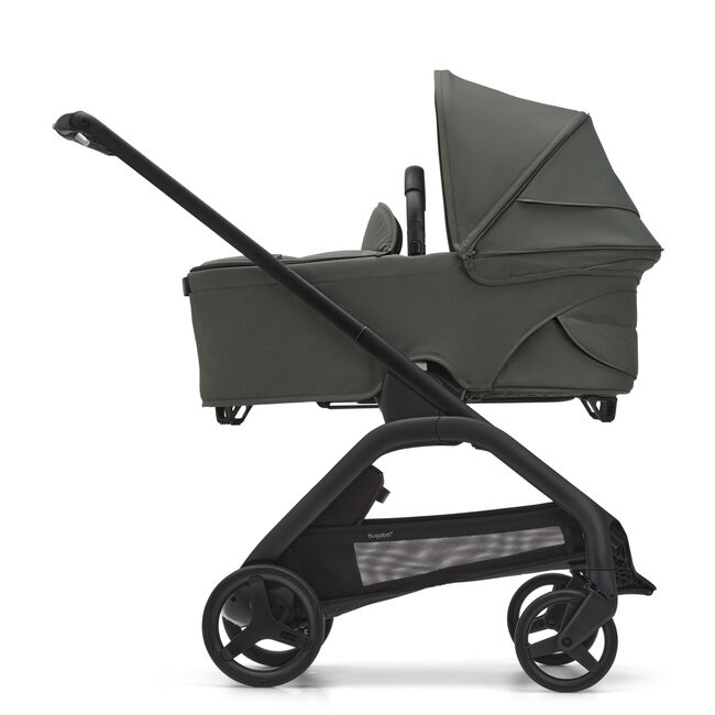 Side view of the Bugaboo Dragonfly bassinet stroller with black chassis, forest green fabrics and forest green sun canopy.