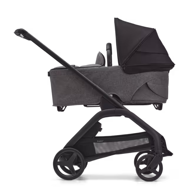 Side view of the Bugaboo Dragonfly bassinet stroller with black chassis, grey melange fabrics and midnight black sun canopy. - Main Image Slide 3 of 16