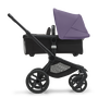 Side view of the Bugaboo Fox 5 carrycot pushchair with black chassis, midnight black fabrics and astro purple sun canopy. - Thumbnail Slide 3 of 16