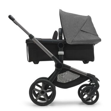 Side view of the Bugaboo Fox 5 carrycot pushchair with graphite chassis, midnight black fabrics and grey melange sun canopy. - view 2