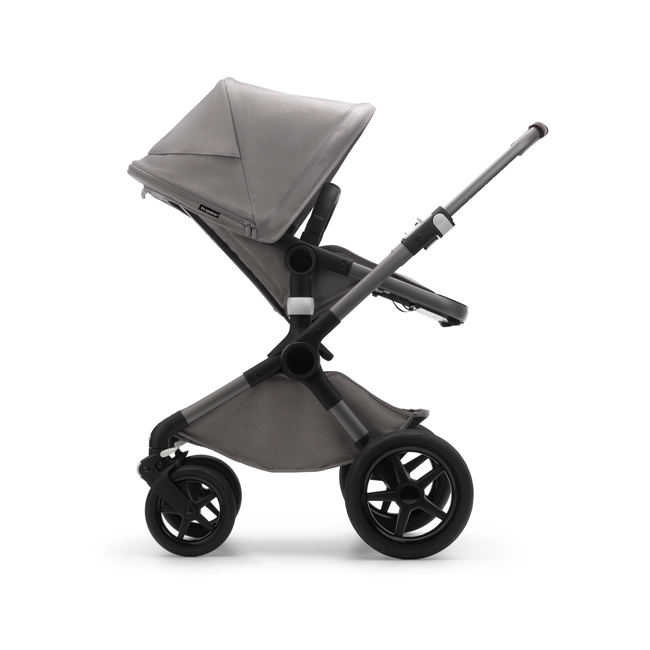 Side view of a Fox 3 seat stroller with graphite frame, light grey fabrics and light grey sun canopy.