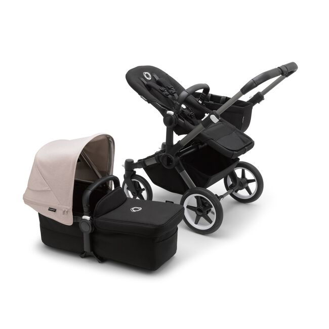 Bugaboo Donkey 5 Mono seat stroller with graphite chassis and midnight black fabrics, plus bassinet with misty white sun canopy.