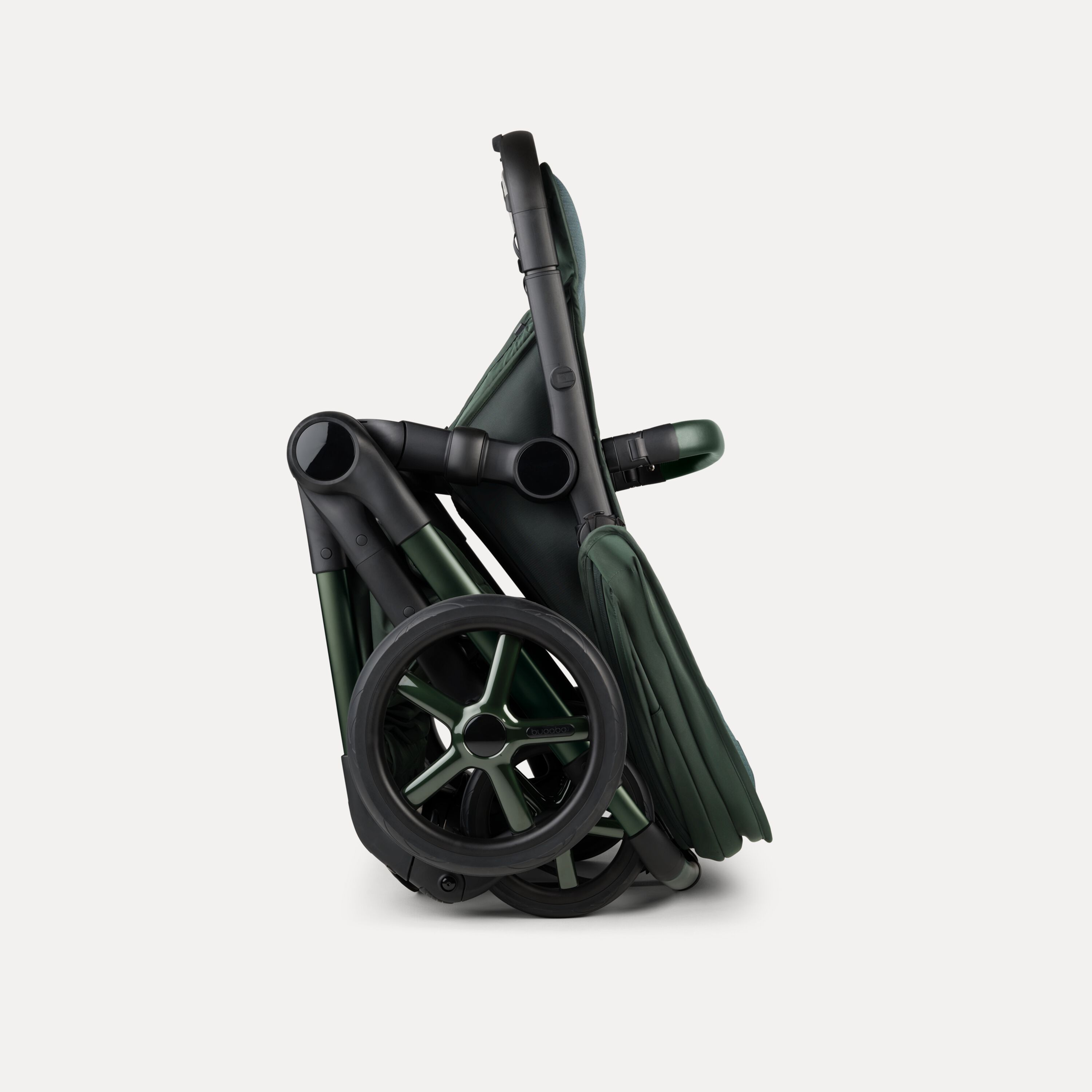 A Bugaboo Fox 5 Noir Limited Edition stroller in Midnight Green, shown in a folded position. - Main Modal Image Slide 10 of 15