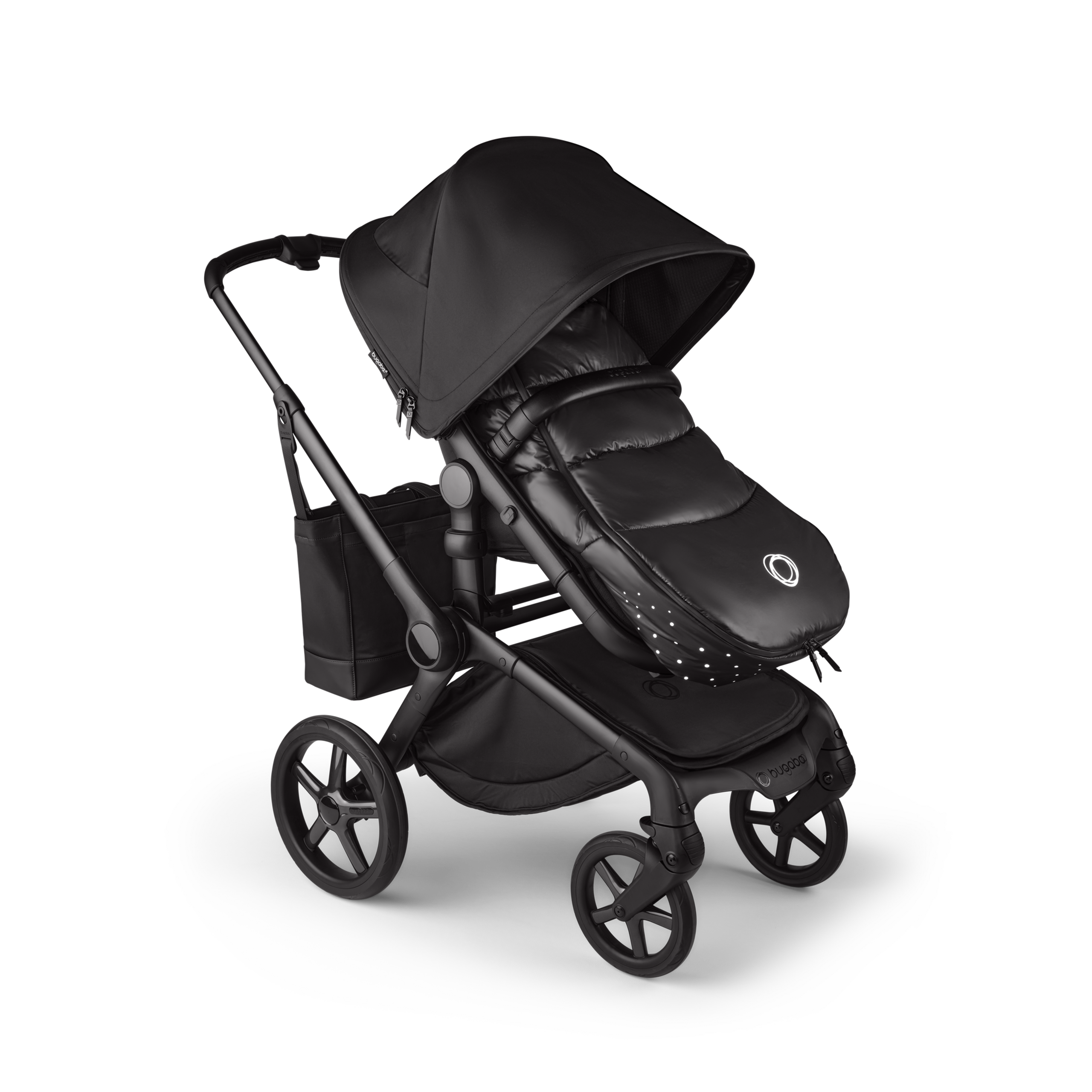 A Bugaboo Fox 5 Noir Limited Edition stroller with a footmuff and changing bag, all in the Black Moonlight colorway. - Thumbnail Slide 15 of 15