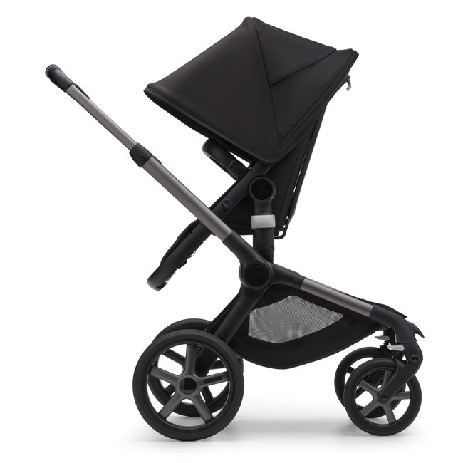 Side view of the Bugaboo Fox 5 seat stroller with graphite chassis, midnight black fabrics and midnight black sun canopy.