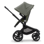 Side view of the Bugaboo Fox 5 seat stroller with black chassis, forest green fabrics and forest green sun canopy. - Thumbnail Slide 4 of 15