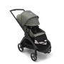 Bugaboo Dragonfly seat pram with black chassis, forest green fabrics and forest green sun canopy. The sun canopy is fully extended.
