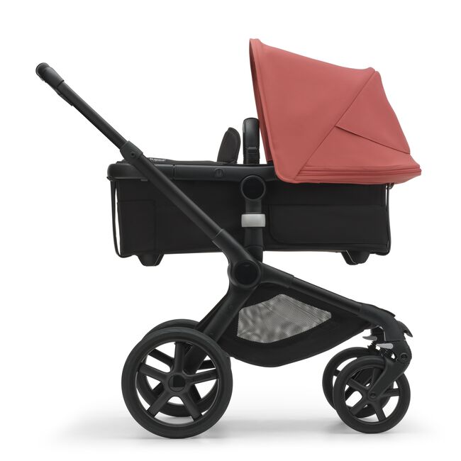 Side view of the Bugaboo Fox 5 carrycot pushchair with black chassis, midnight black fabrics and sunrise red sun canopy. - Main Image Slide 3 of 16