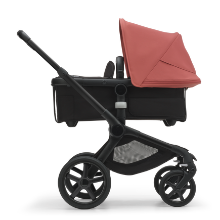 Side view of the Bugaboo Fox 5 carrycot pushchair with black chassis, midnight black fabrics and sunrise red sun canopy. - view 2
