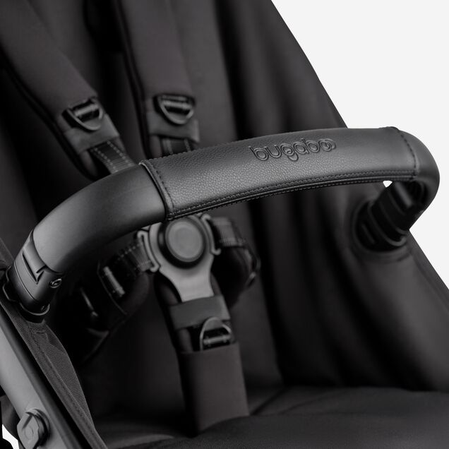 A close-up of the seat of the Bugaboo Kangaroo 2-in-1 stroller, with focus on the carry handle and the five-point safety harness. - Main Image Slide 15 of 18