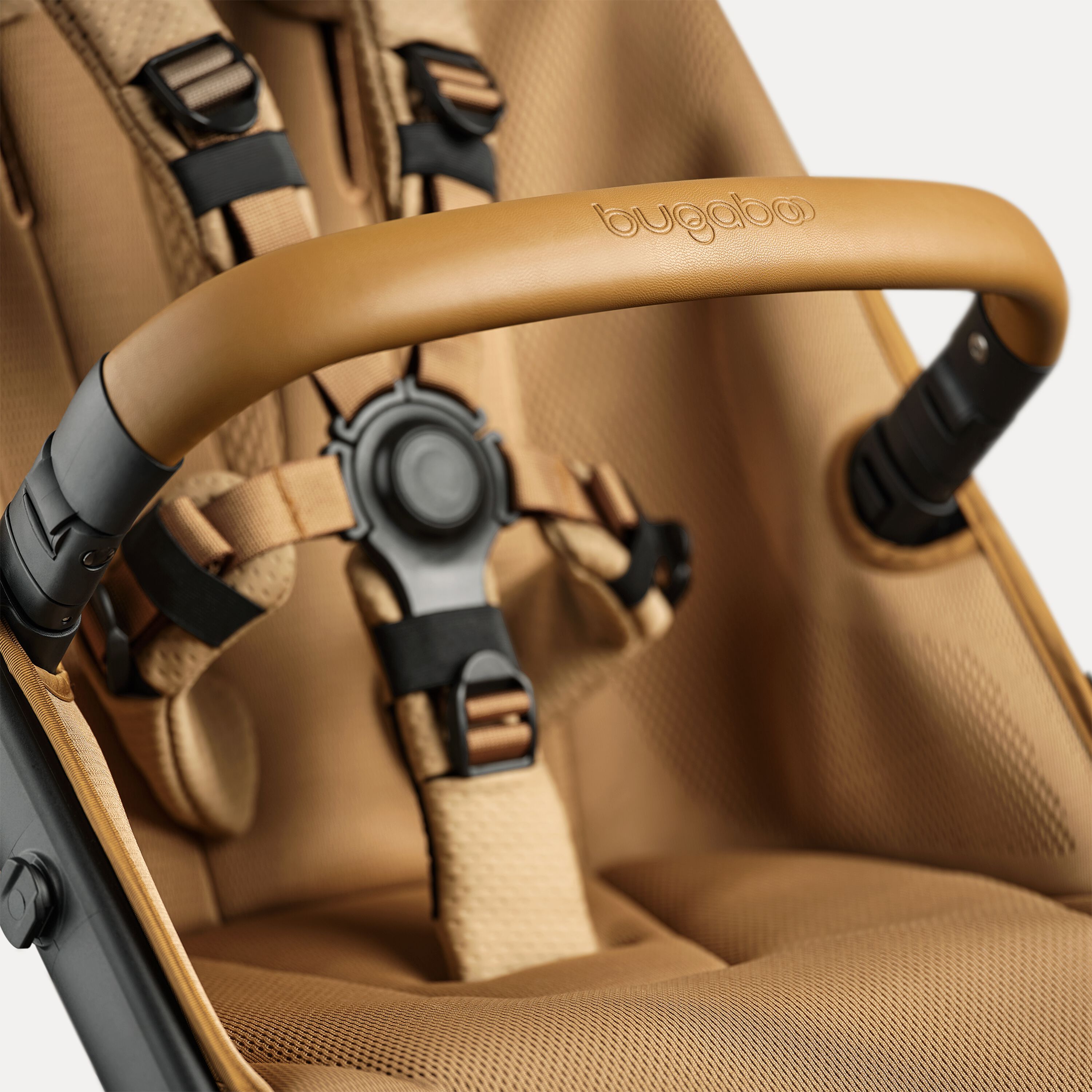 A close up of the bumper bar and seat of the Bugaboo Fox 5 Noir Limited Edition Amber Glow. - Main Modal Image Slide 13 of 15