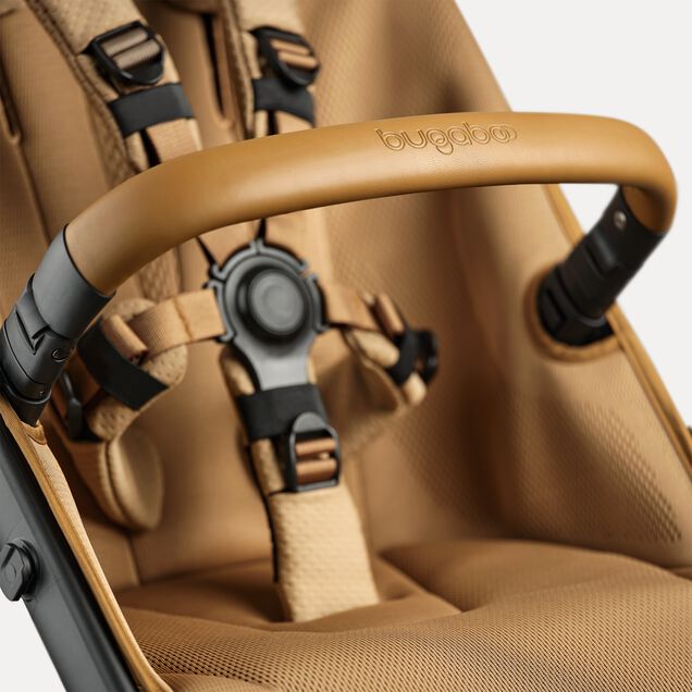 A close up of the bumper bar and seat of the Bugaboo Fox 5 Noir Limited Edition Amber Glow. - Main Image Slide 13 of 15