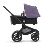 Side view of the Bugaboo Fox 5 bassinet stroller with black chassis, midnight black fabrics and astro purple sun canopy. - Thumbnail Slide 2 of 15
