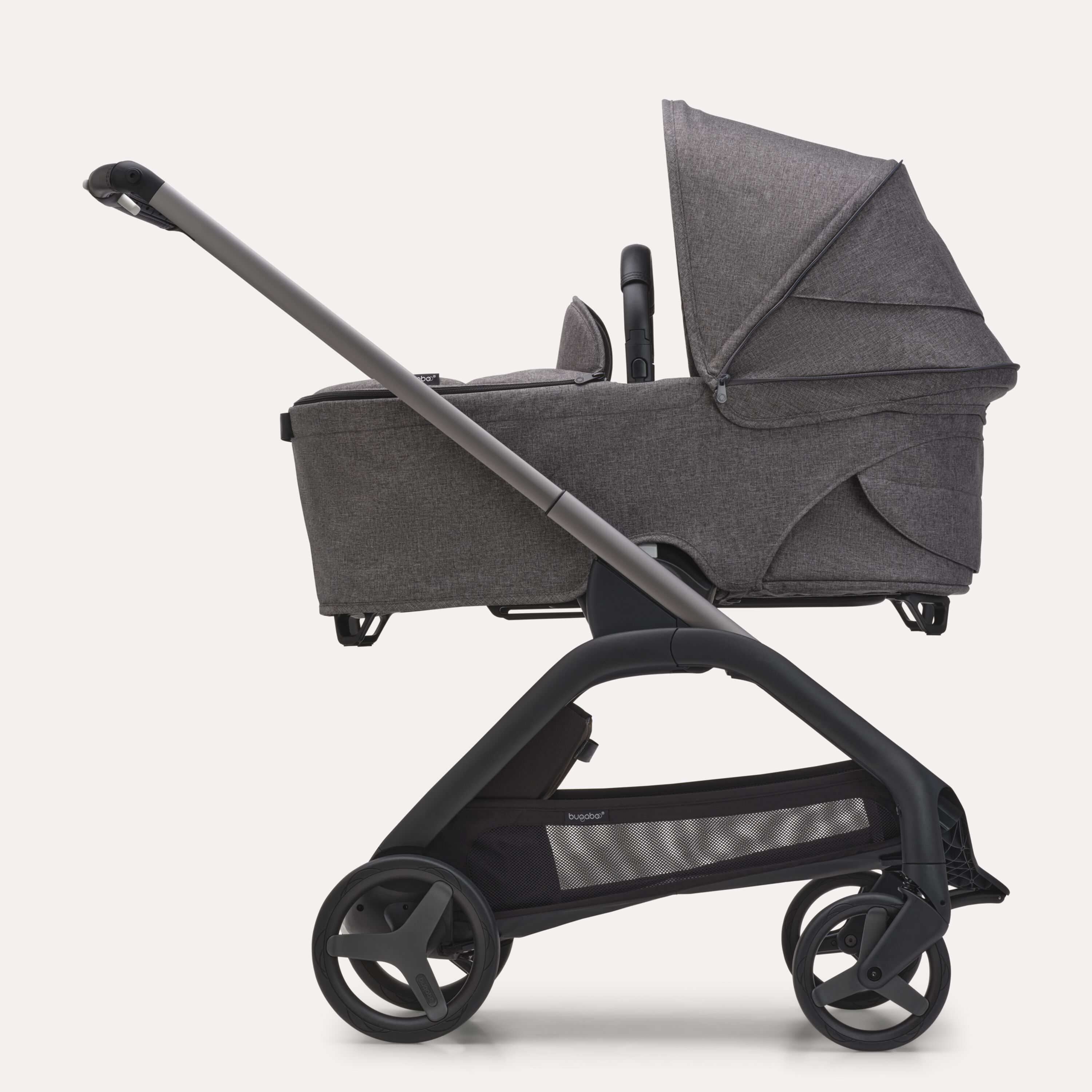 Side view of the Bugaboo Dragonfly bassinet stroller with graphite chassis, grey melange fabrics and grey melange sun canopy. - Main Modal Image Slide 3 of 16
