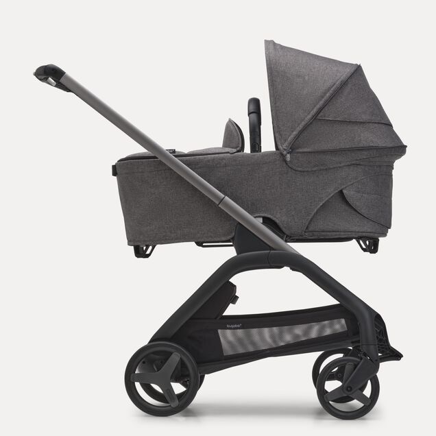 Side view of the Bugaboo Dragonfly bassinet stroller with graphite chassis, grey melange fabrics and grey melange sun canopy. - Main Image Slide 3 of 16