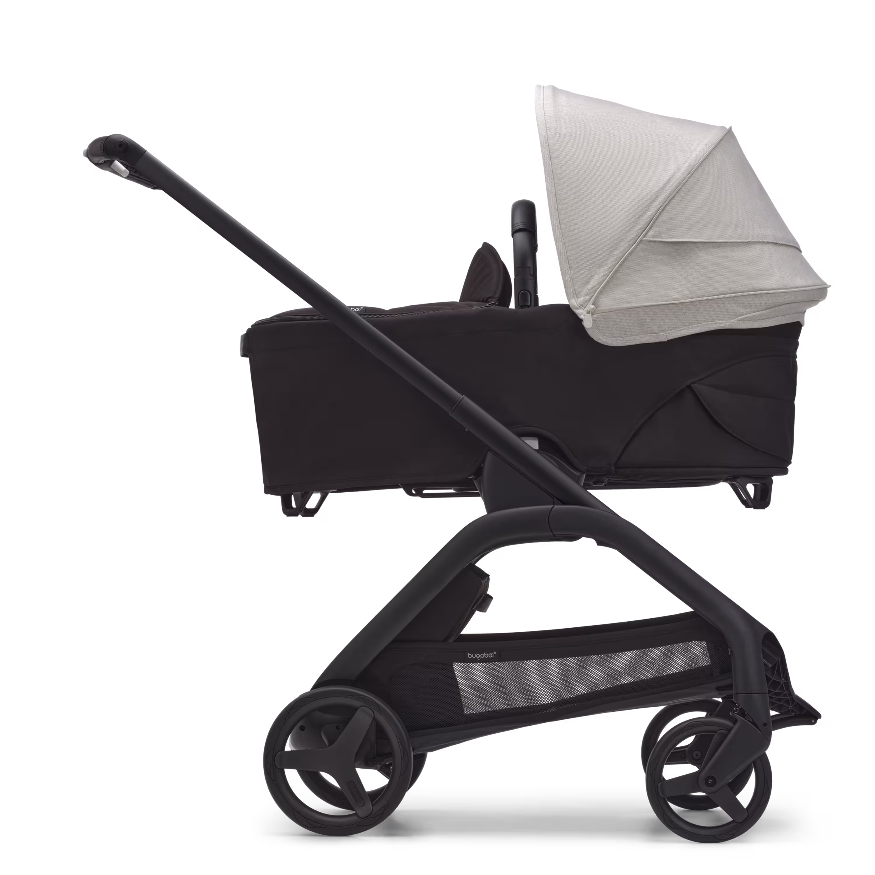 Side view of the Bugaboo Dragonfly bassinet stroller with black chassis, midnight black fabrics and misty white sun canopy. - Main Modal Image Slide 3 of 16