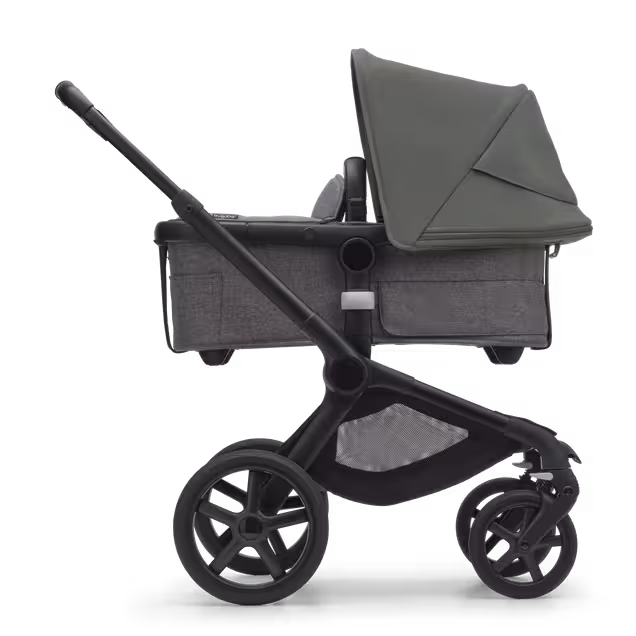 Side view of the Bugaboo Fox 5 bassinet stroller with black chassis, grey melange fabrics and forest green sun canopy. - Main Image Slide 2 of 12