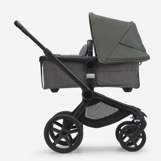 Side view of the Bugaboo Fox 5 bassinet stroller with black chassis, grey melange fabrics and forest green sun canopy. - Main Image Slide 2 of 12